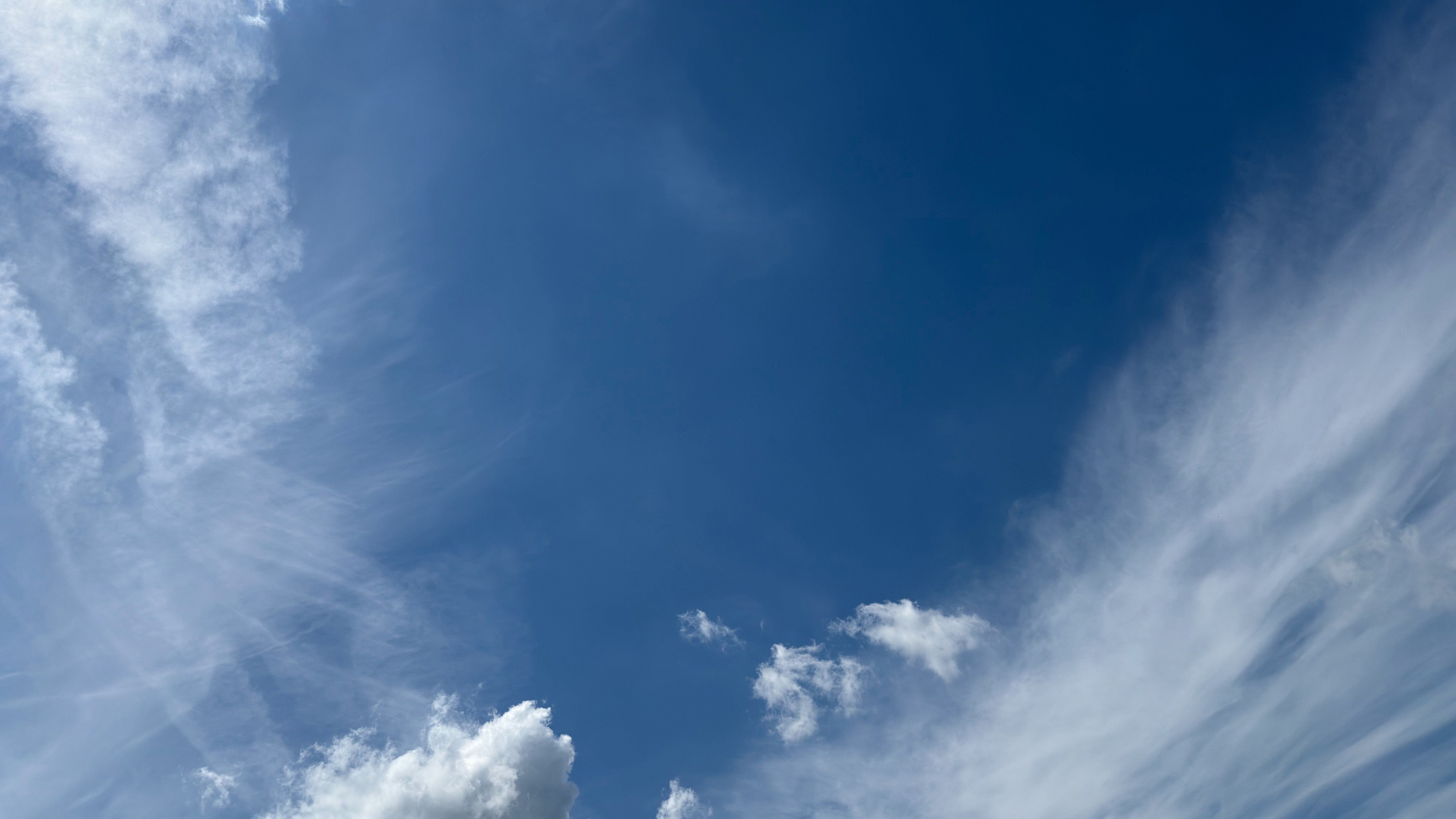 Weitläufiger blauer Himmel mit zarten Wolken